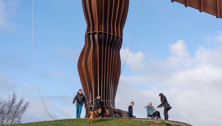 A family enjoying the outdoors at the foot of the Angel of the North