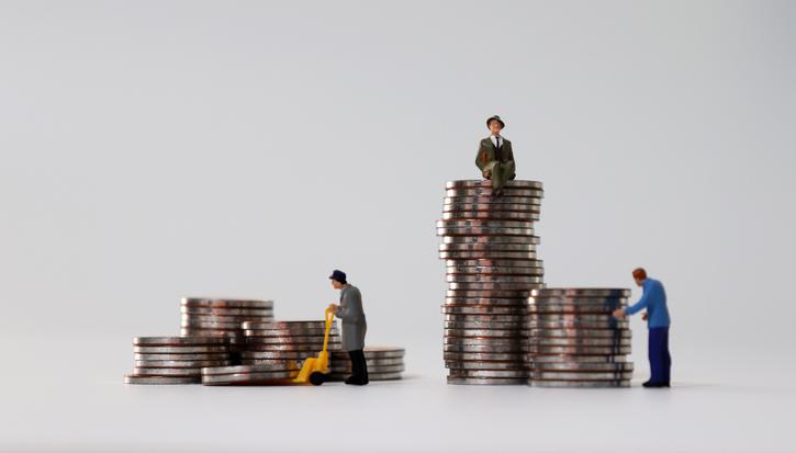 A wealthy man sits on a stack of coins while an older woman and a less wealthy man stand below him next to much smaller stacks of coins