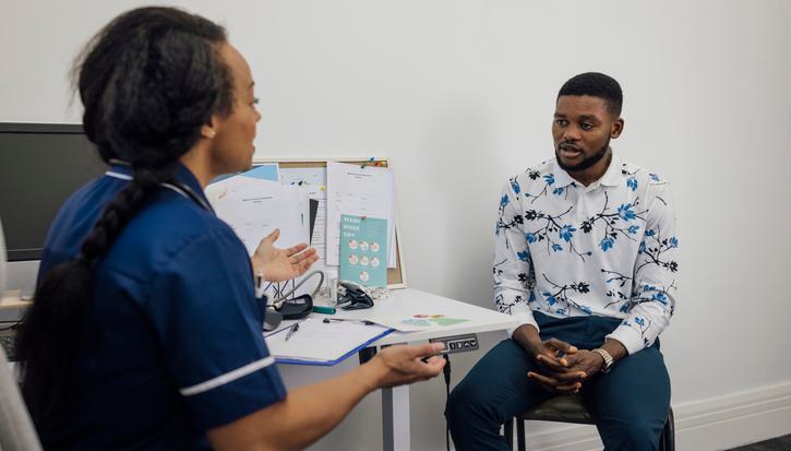 A medical professional speaking to a patient