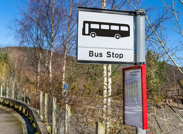 A bus stop sign in a country lane in rural Scotland.