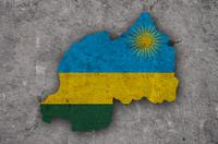 Silhouette of Rwanda in the colours of the Rwandan flag against a concrete backdrop